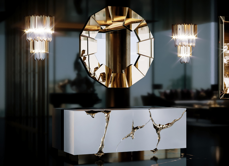 a dark modern entryway with a gold mirror and a white and gold sideboard