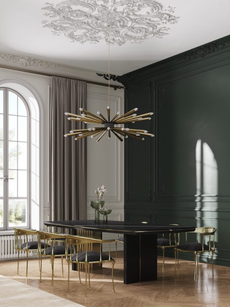 green dining room with  agold suspension lamp, a black dining table and black and gold dining chairs