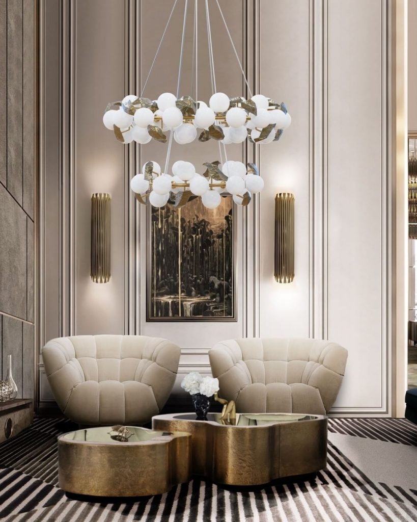 best sellers - suspension lamp with golden details in a living area with two nude armchairs and a golden and black center table