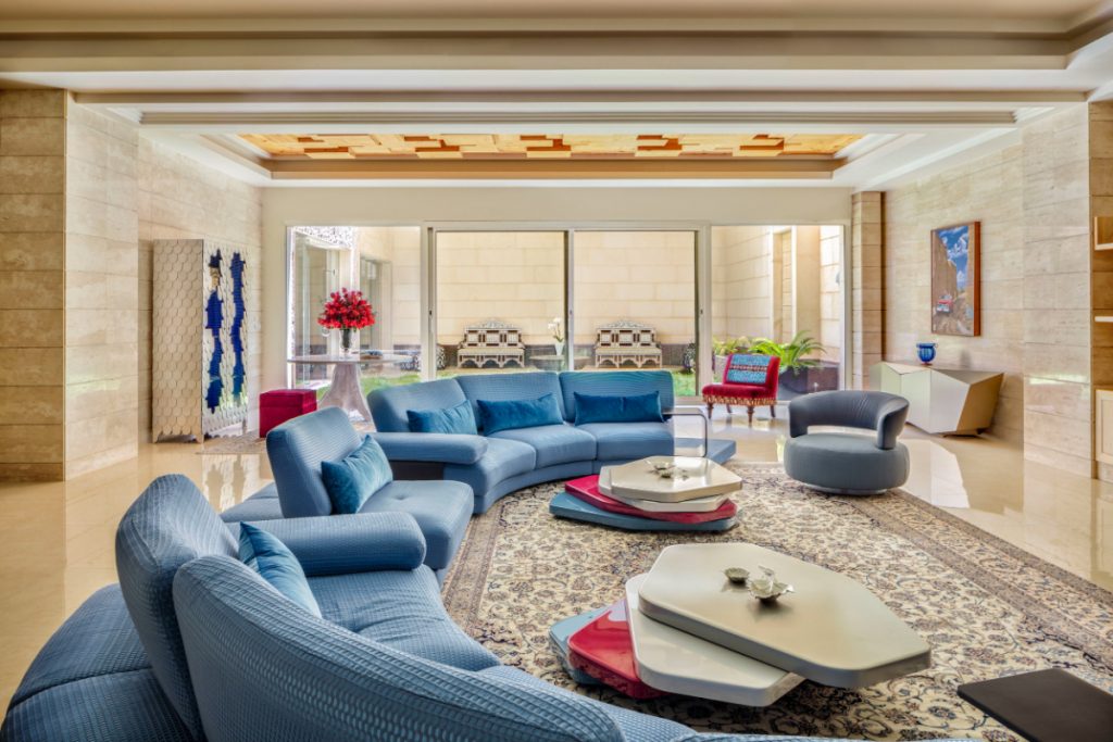 Sumptuous Palace - colourful living room with a blue sofa, a blue armchair, two center tables, a silver diamond sideboard, a white and blue cabinet