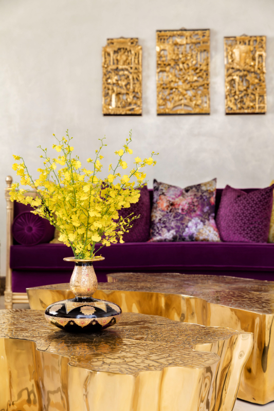 Sumptuous Palace - white living room with purple sofas and armchairs, golden center tables and golden details on the wall