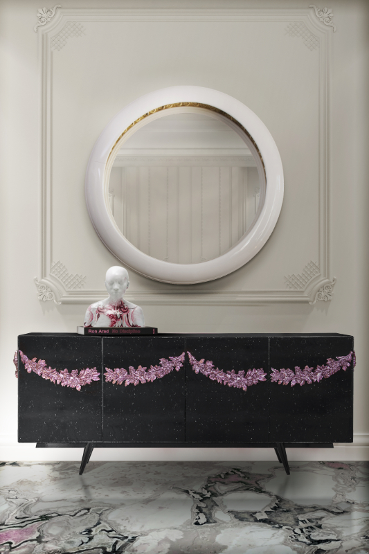 Entryway - black sideboard with flowers details in pink. round and white round mirror