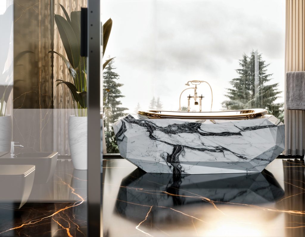 luxury bathroom -Luxurious bathroom featuring a modern freestanding bathtub with a faceted white marble exterior and bold black veining. The bathtub has a sleek gold rim and gold fixtures. The floor is made of glossy black marble with striking gold veins. Large windows behind the bathtub reveal a misty view of tall evergreen trees, allowing natural light to fill the space. To the left, a white marble planter holds a tall green plant, adding a touch of nature indoors.