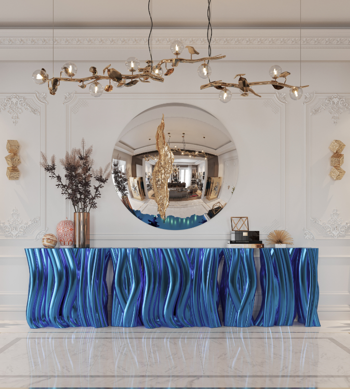 curved furniture - luxury blue curved sideboard, a round mirror with golden details, a nature related golden suspension lamp and two golden sconces on a boiserie technique wall