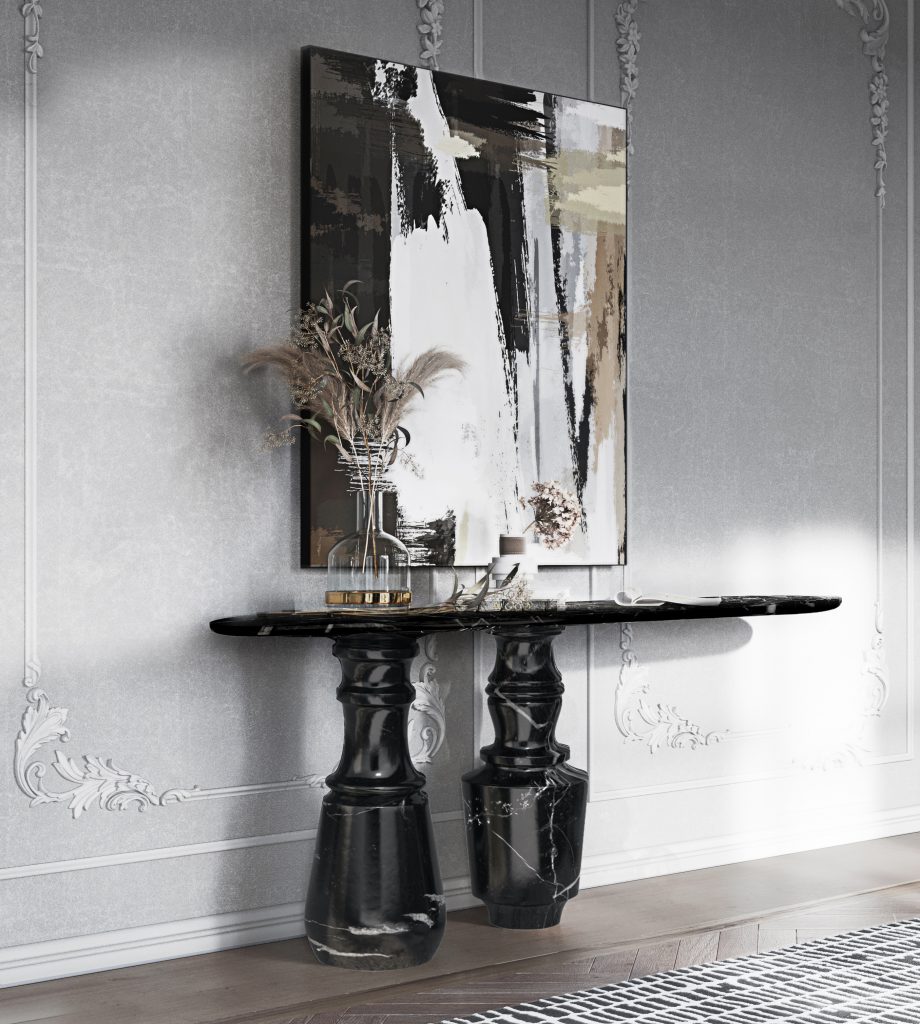 Most-Loved Pieces For Entryways - A white and black entryway wih a painting on the wall in those colors and a black marble console