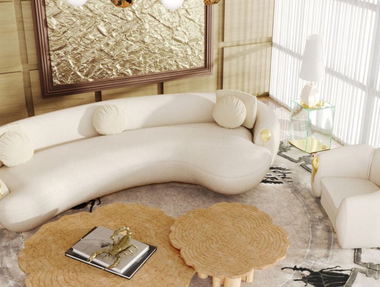 luxury living room with a cream curved sofa with golden details and a cream armchair with golden details, a set of three center tables in poplar root and a white table lamp and a filigree decor above the center table