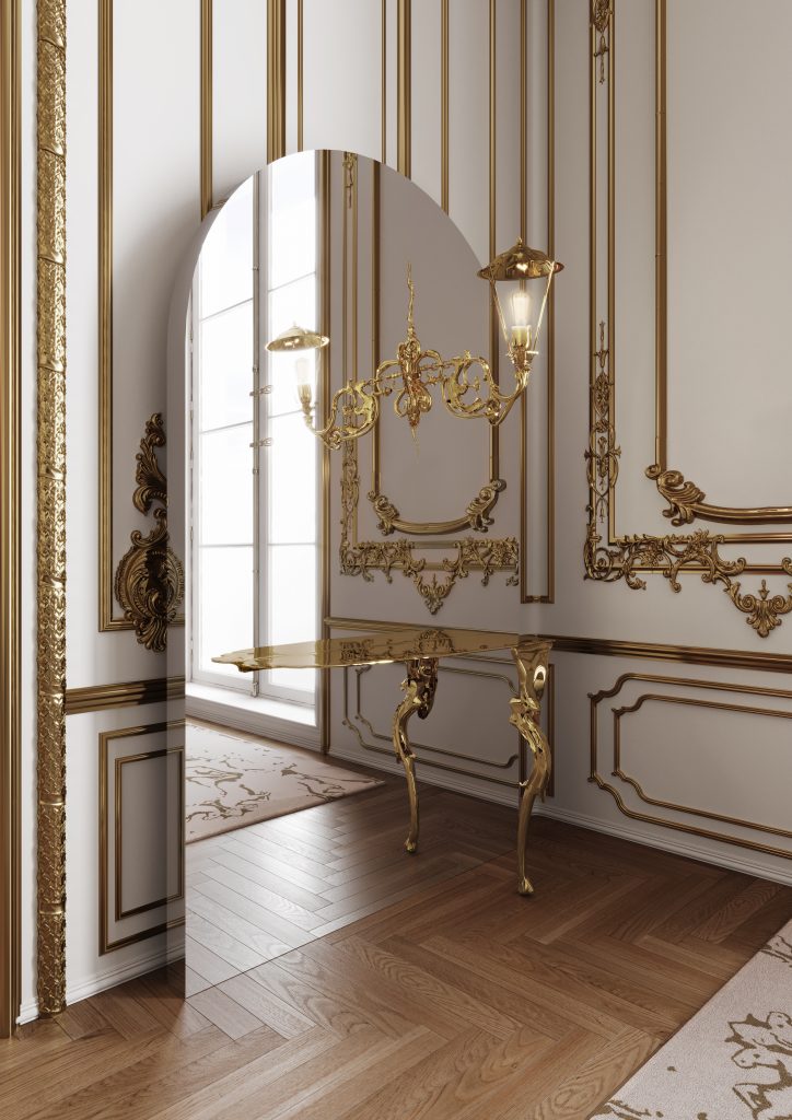 Modern Console Tables, A minimalist gold console table standing next to a large, floor-length arched mirror reflecting a bright room with intricate gold wall paneling and a chandelier.