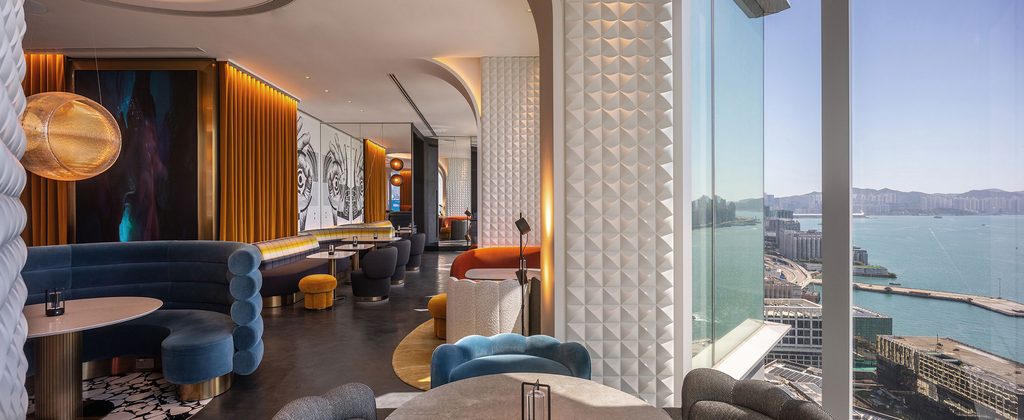 Stylish harbor view bar with colorful velvet seating, interior designers in Hong Kong