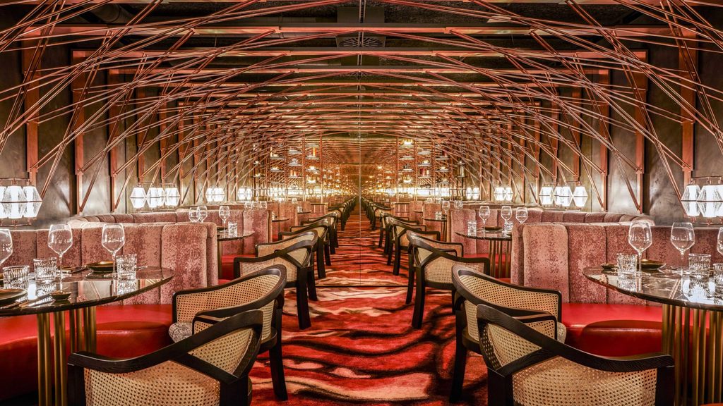 Atmospheric restaurant with arched ceiling structure and booth seating, interior designers in Hong Kong