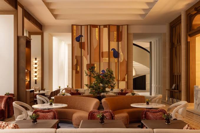 Warm upscale restaurant seating with artistic wooden wall panel, interior designers in Hong Kong