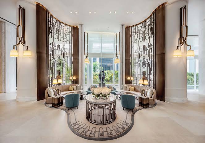 Elegant hotel foyer with decorative screens and curved sofas, interior designers in Hong Kong
