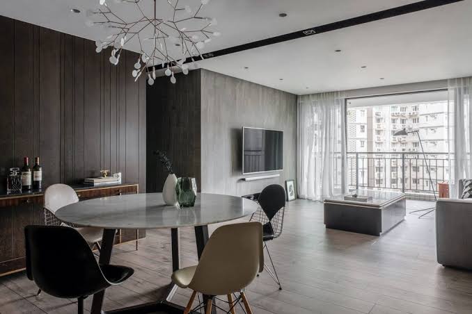 Contemporary dining area with round marble table and chandelier, interior designers in Hong Kong