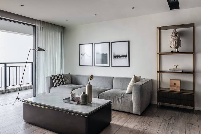 Modern minimalist living room with grey sofa and artwork, interior designers in Hong Kong