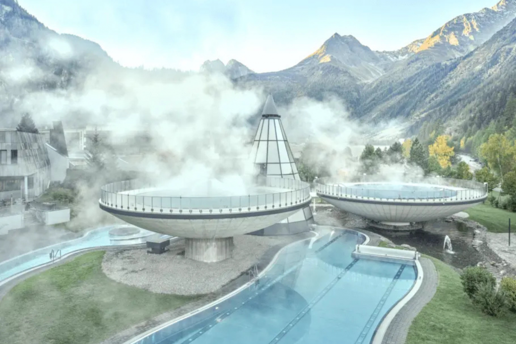 Luxury Thermal Baths in Europe, Futuristic elevated saucer-shaped thermal pools at Aqua Dome Längenfeld with Austrian Alps in the background.