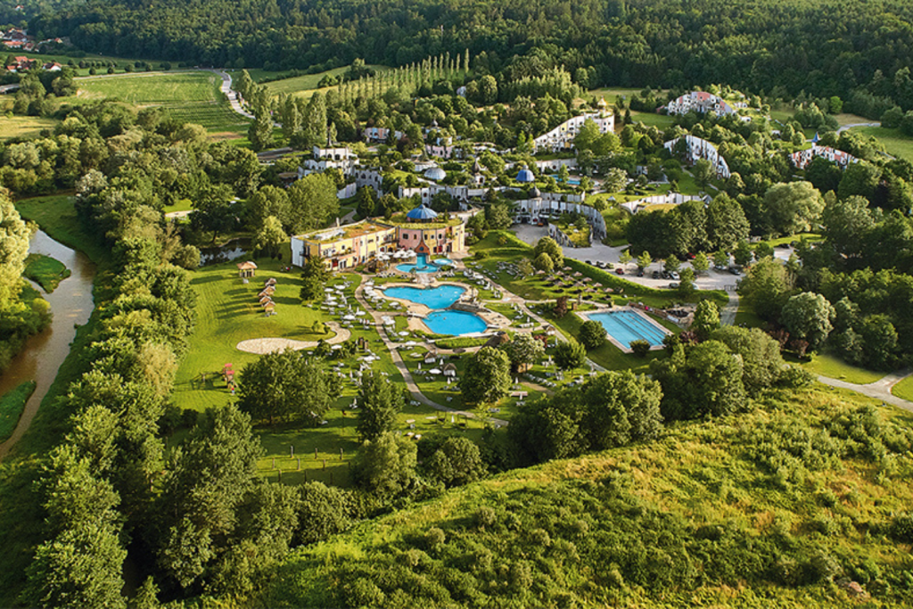 Luxury Thermal Baths in Europe, Whimsical colorful architecture and rolling green roofs of the Rogner Bad Blumau spa in Austria.