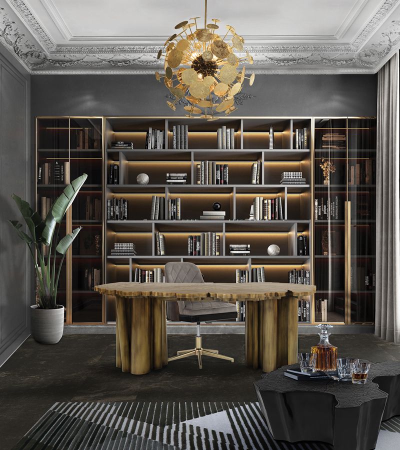 gold desk, grey walls, gold bookcase, gold suspension lamp, grey chair, plant, grey side table, grey floor, white and black rug, office interiors