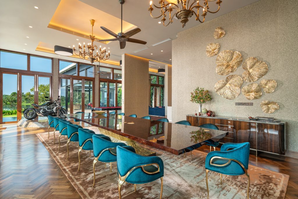 Luxury Residence in Sri Lanka, luxury dining room with long wooden table, upholstered chairs and elegant lighting