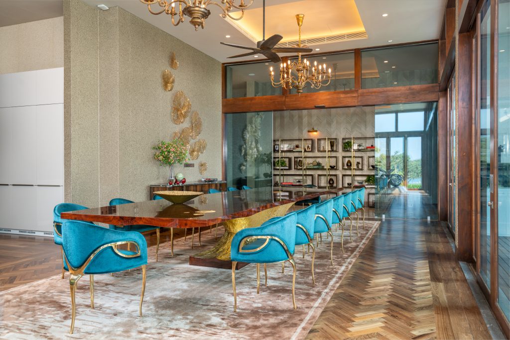 Luxury Residence in Sri Lanka, refined dining area with statement table, blue velvet chairs and decorative wall art
