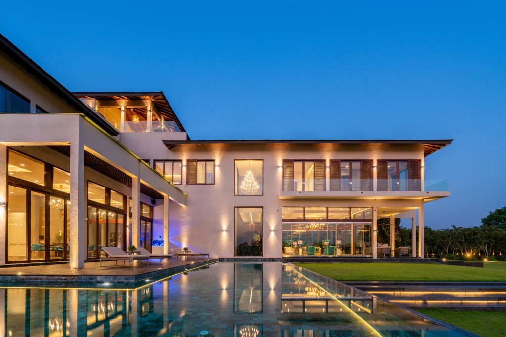 Luxury Residence in Sri Lanka, exterior view at dusk with illuminated facade, swimming pool and contemporary architecture