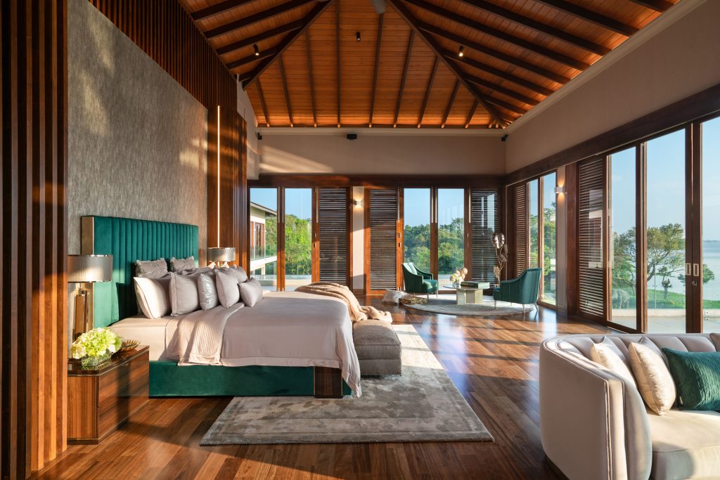 Luxury Residence in Sri Lanka, spacious bedroom with wooden ceiling, panoramic windows and serene seating area