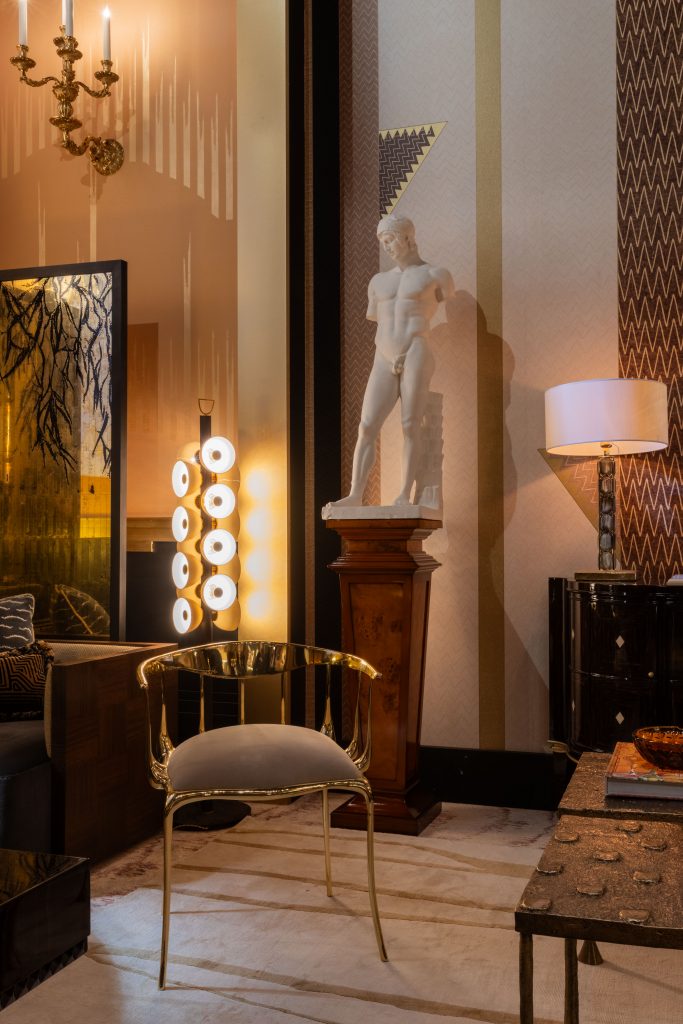 gold and cream chair, white statue, cream walls, floor lamp, table lamp, milan design week
