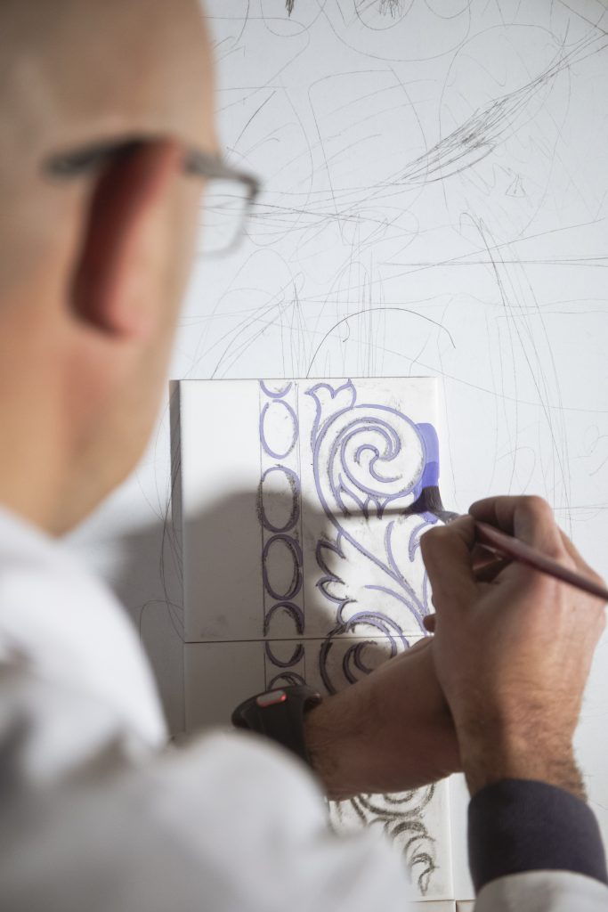 man paiting in tiles milan design week