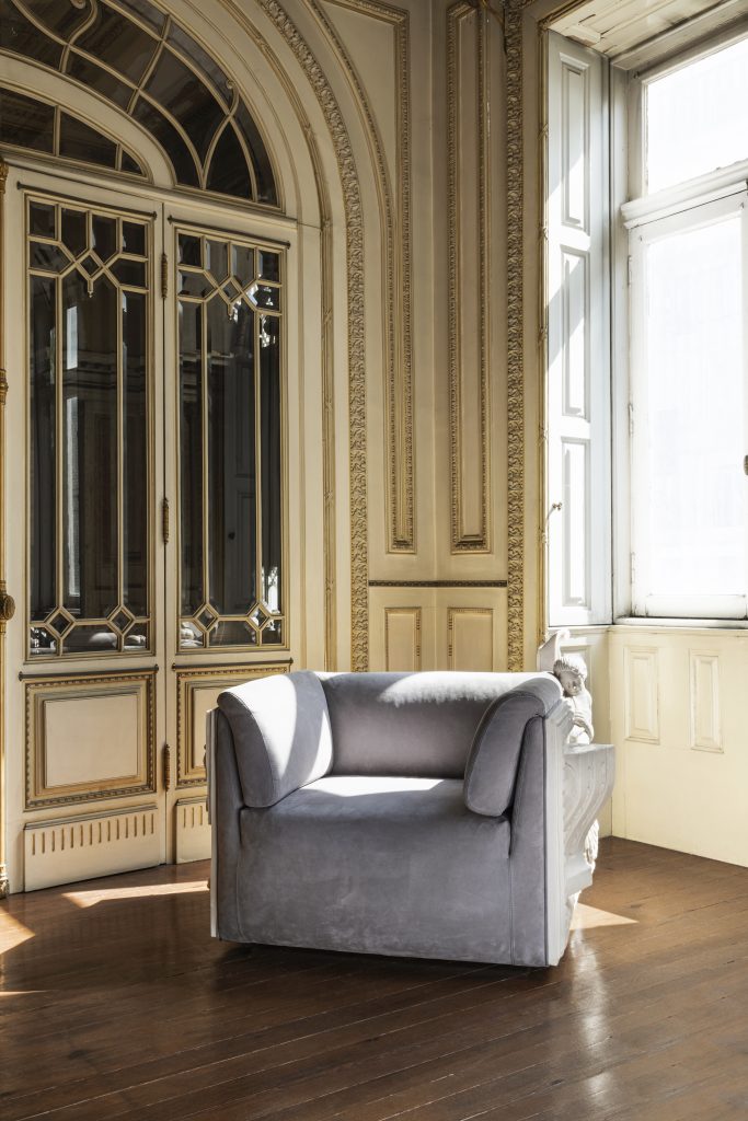beige wall, grey and white armchair, modern armchair