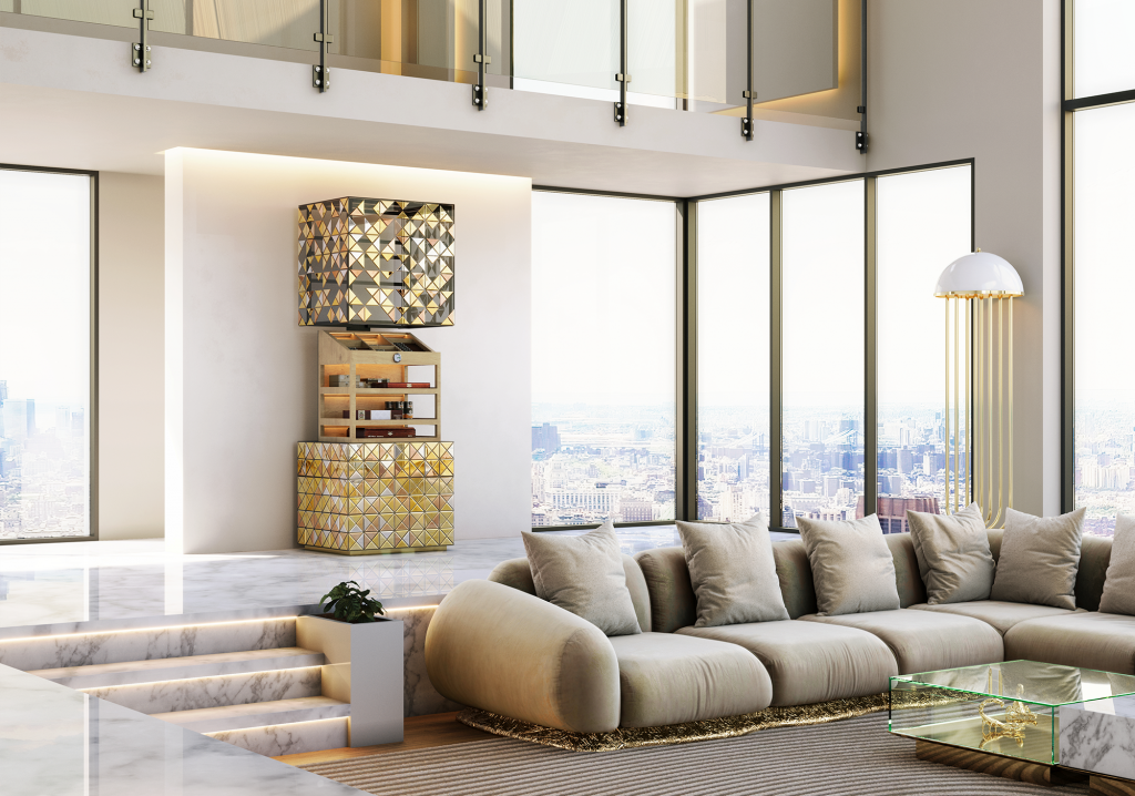Habano Cabinet, A wide shot of a high-end, modern living room with floor-to-ceiling windows overlooking a city skyline. The golden pixelated cabinet stands open against a white pillar. In the foreground, a large, curved beige sectional sofa sits on a textured rug near a marble coffee table.