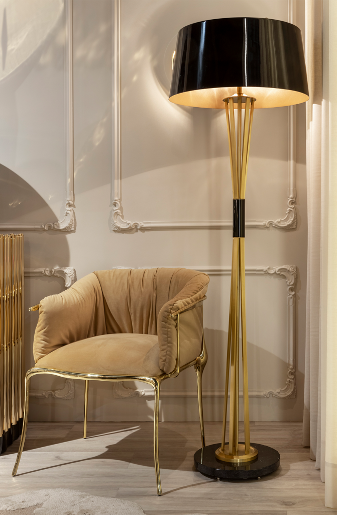 white walls, black and gold floor lamp, cream and gold armchair, modern armchair