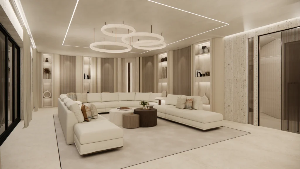 Contemporary lounge with a large cream U-shaped sectional sofa, layered round coffee tables, travertine wall paneling with built-in display niches, and a triple-ring pendant light fixture on the ceiling. kunal trehan