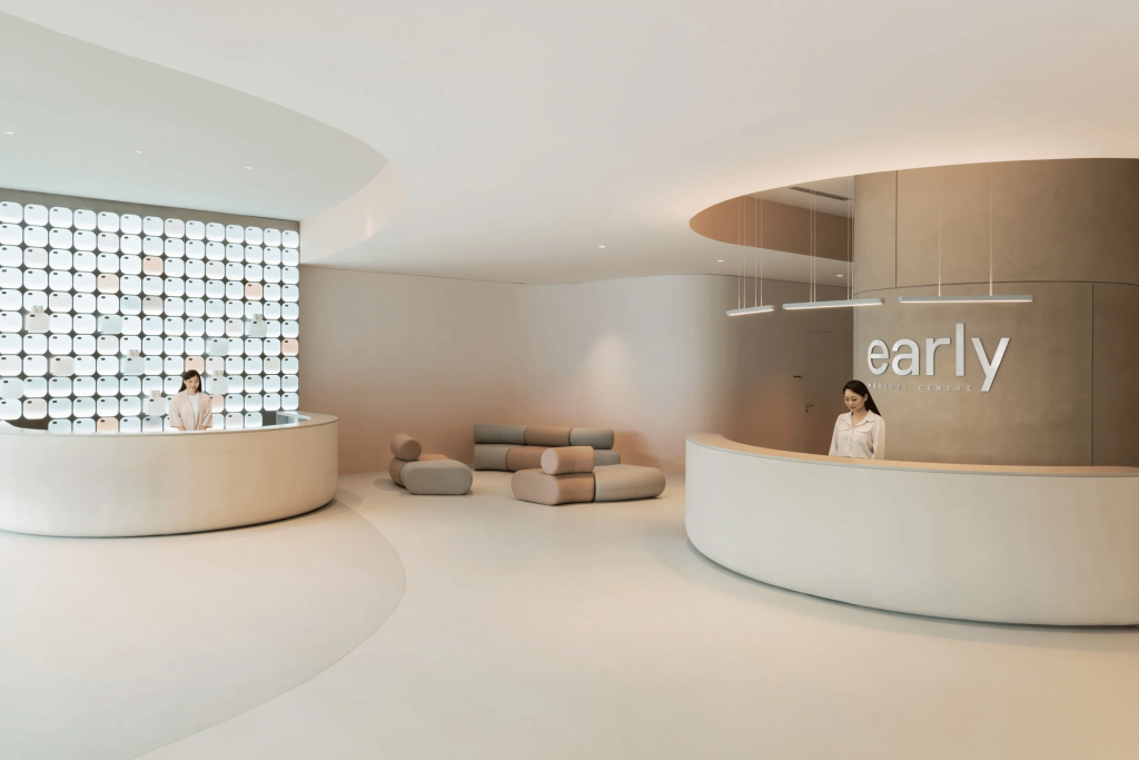 Modern minimalist medical center reception area with curved desks, sleek lighting, and neutral tones, luxury brand