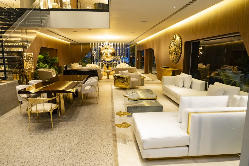 Luxury interior design with Boca do Lobo furniture, gold details, marble coffee tables and elegant contemporary living room.