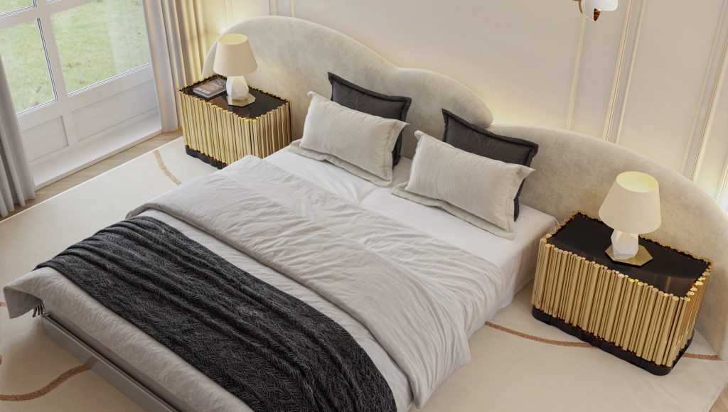 Luxury bedroom featuring two Symphony Nightstands with golden brass tubes and black surfaces beside a curved upholstered bed in neutral tones.
