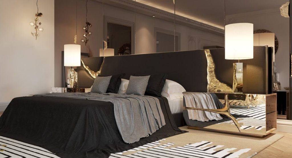 Sophisticated luxury bedroom featuring the Lapiaz Black Headboard and Lapiaz Nightstand, with sculptural gold details, mirrored surfaces, and elegant lighting.