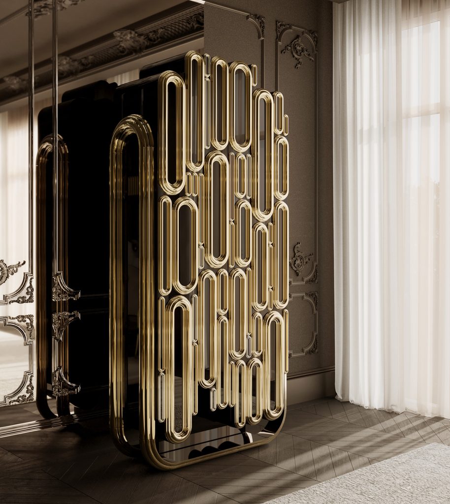 Sophisticated luxury foyer featuring the Oblong Gold Cabinet with sculptural golden tubes, glossy black surfaces, ornate wall moldings, and soft natural light.
