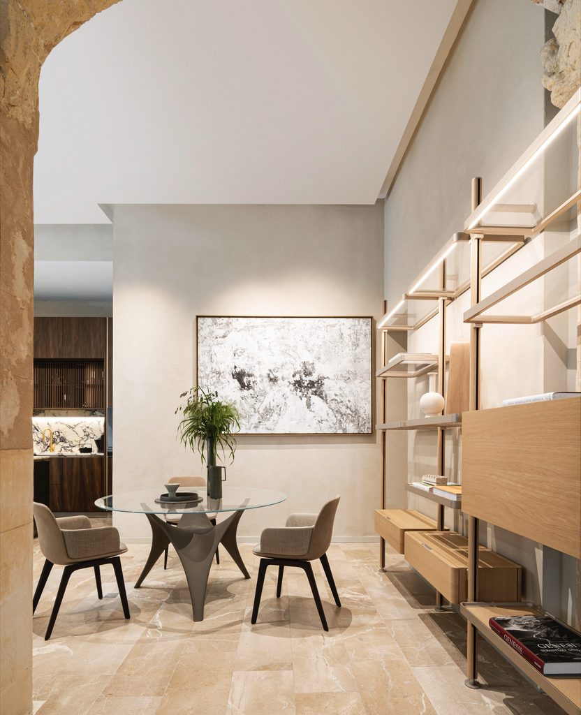Minimalist dining room set with glass table and shelving, luxury showrooms in Palma de Mallorca