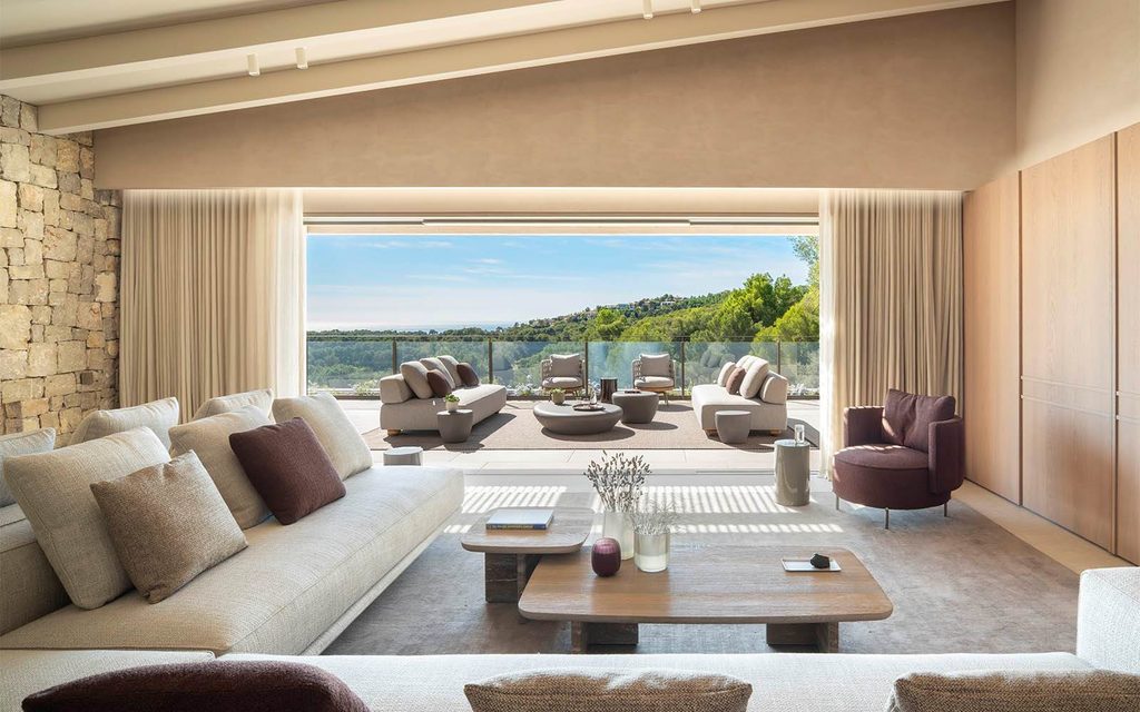 Luxurious indoor-outdoor living room opening to mountain view, luxury showrooms in Palma de Mallorca