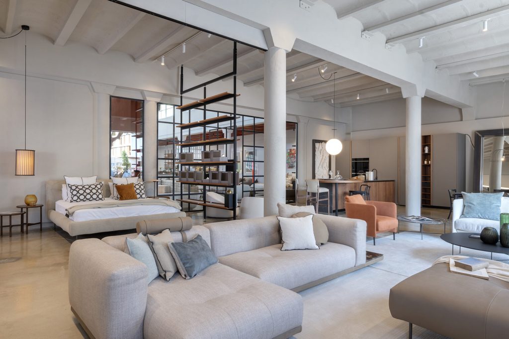 Spacious industrial loft showroom with modern furniture layout, luxury showrooms in Palma de Mallorca