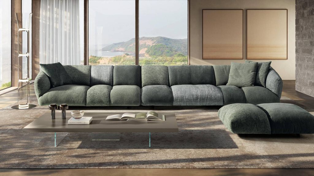 Plush green sectional sofa overlooking scenic mountain view, luxury showrooms in Palma de Mallorca