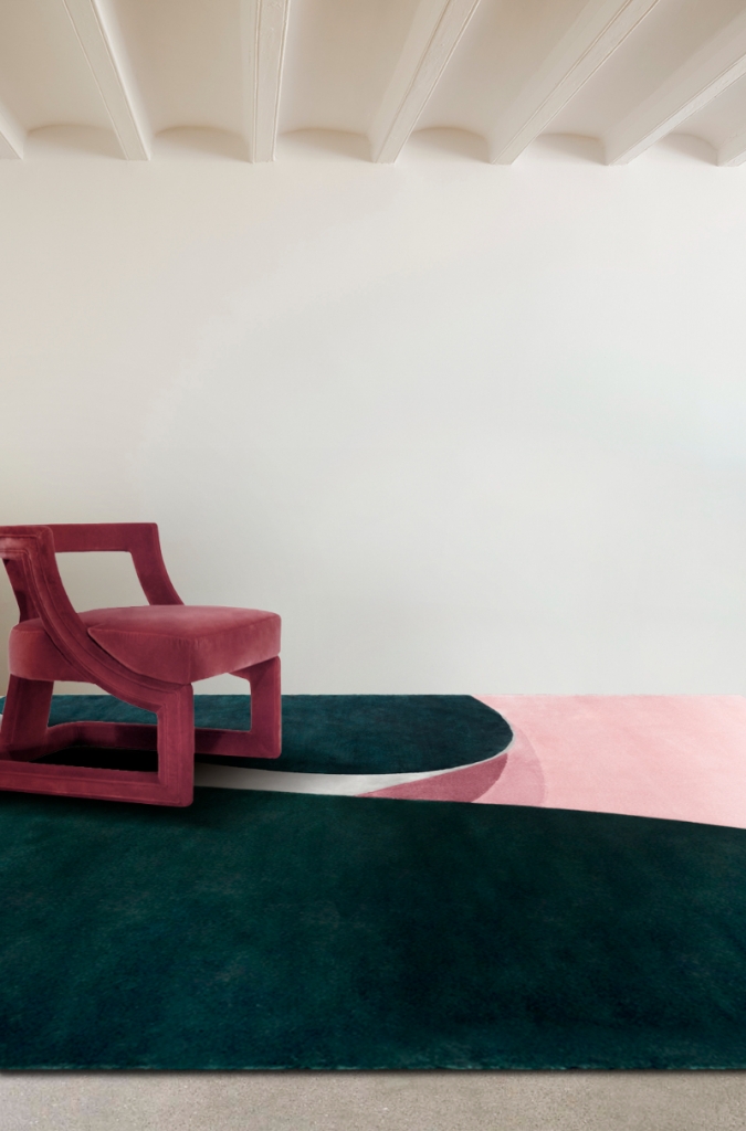 pink chair and a colorfol rug