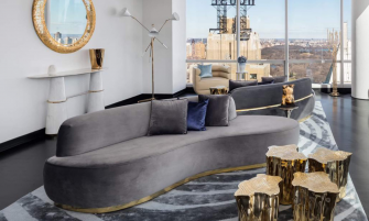 modern living room with a grey velvet sofa and gold center table