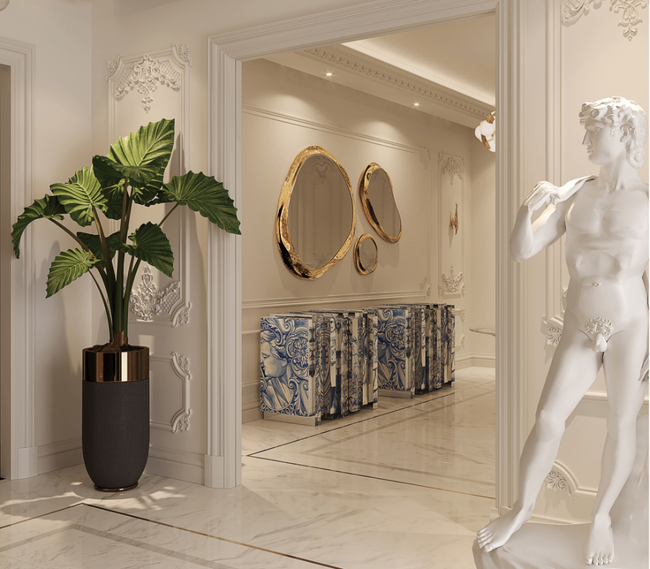 trend alert - luxury entryway with a golden set of three mirrors, two tiles sideboards, a statue and a plant