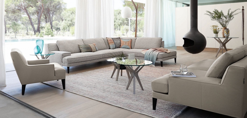 50 luxury center tables - living room with grey sofas and armchair two center tables with wooded legas and a clear glass top