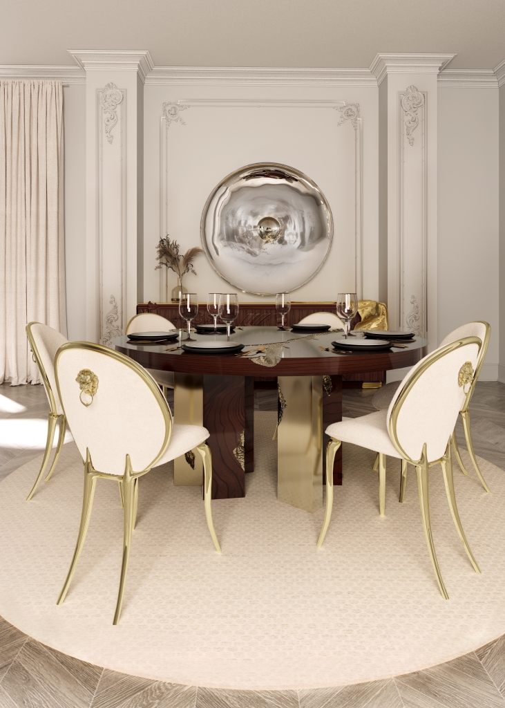 50 luxury dining rooms - luxurious dining room with a round wooden dining table with gold detailing, chairs with light fabric, gold frame and legs, in the background a wooden sideboard with gold detailing and a wall mirror