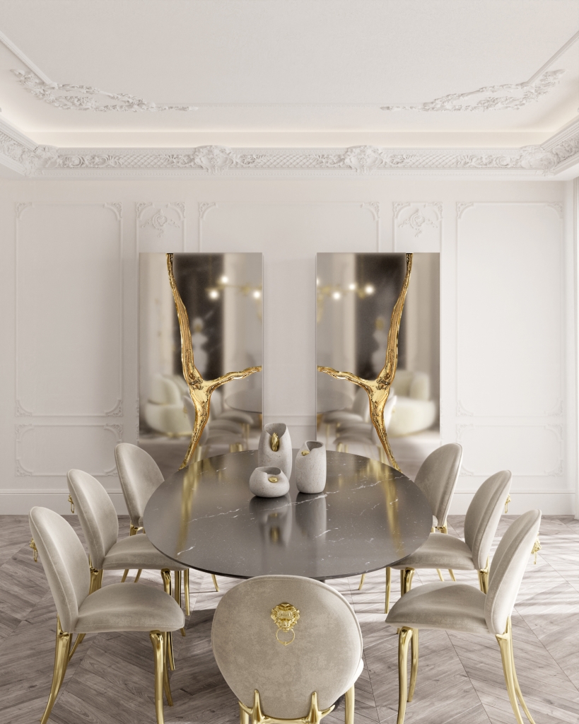 50 luxury dining rooms - luxurious dining room with a black marble dining table, beige velvet chairs with gold legs, two silver cabinets in the back with a gold slit down the middle