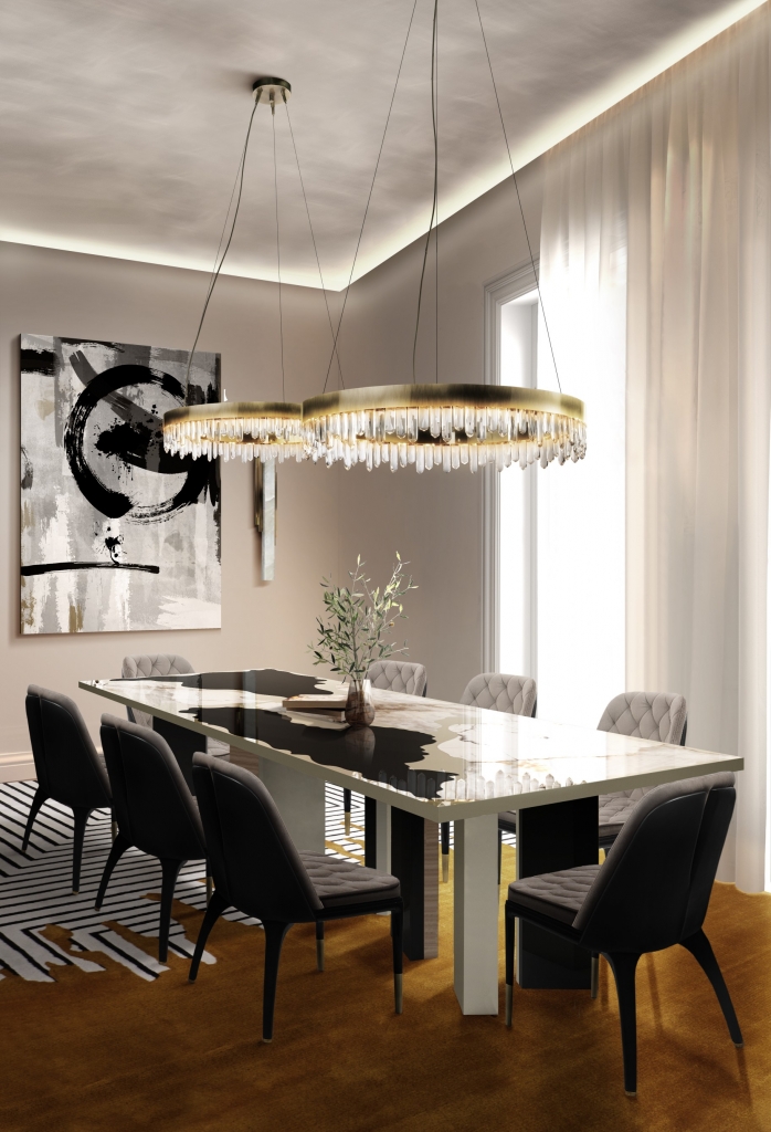50 luxury dining rooms - luxury dining room with black and white dining table and chairs with grey fabric and glossy wooden backs, above the table two round crystal suspension lamps with gold detailing