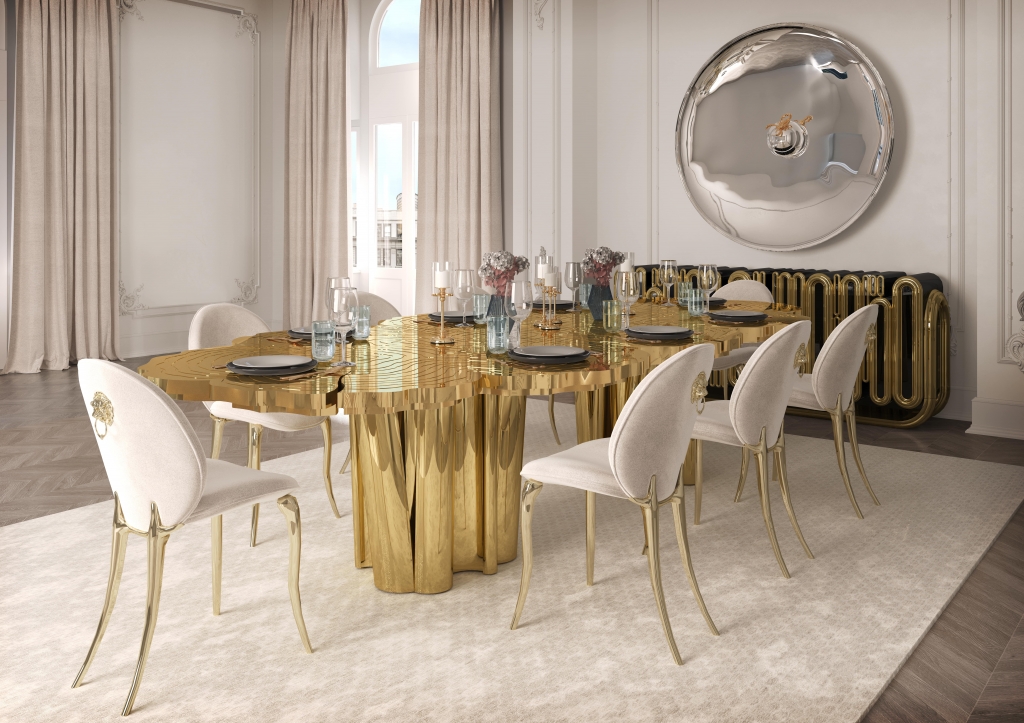 50 luxury dining rooms - luxurious dining room with a golden table reminiscent of a tree, chairs with beige fabric, golden legs and a small golden lion detail on the back, a golden sideboard with round details and a wall mirror at the back of the room