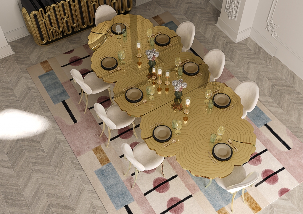 50 luxury dining tables - luxurious dining room with a golden table reminiscent of a tree, chairs with beige fabric, golden legs and a small golden lion detail on the back, a golden sideboard with round details and a wall mirror at the back of the room