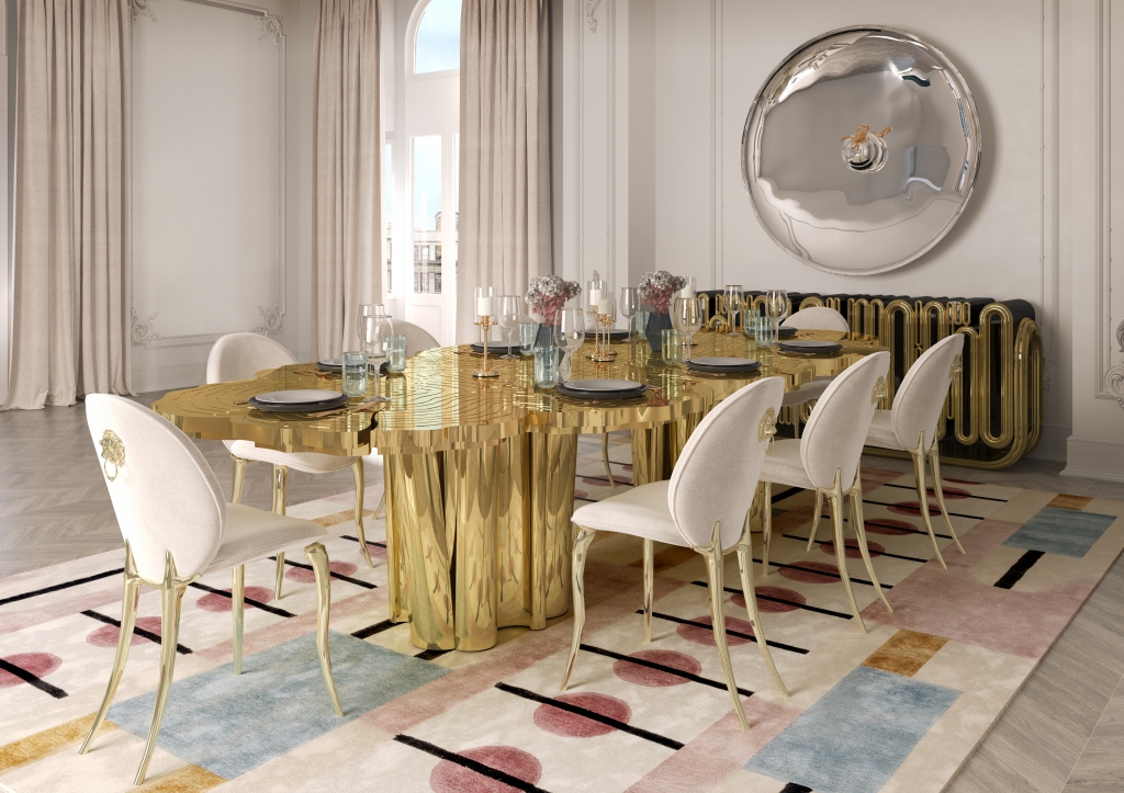 50 luxury dining tables - luxurious dining room with a golden table reminiscent of a tree, chairs with beige fabric, golden legs and a small golden lion detail on the back, a golden sideboard with round details and a wall mirror at the back of the room