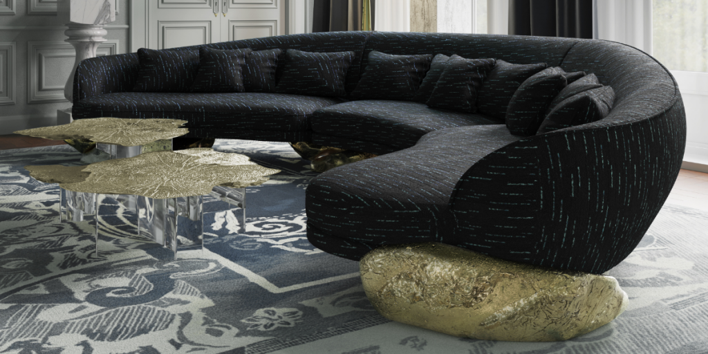 Sculptural Design Angra Sofa by Boca do Lobo in a contemporary living space with a curved silhouette and a signature gold leaf hammered brass base.